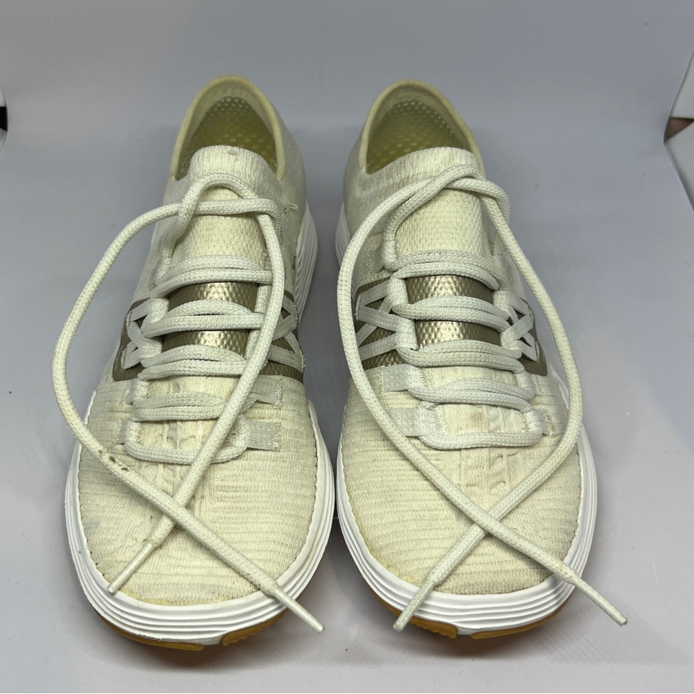 Under Armour White and Gold Athletic Shoes Sleek Design
